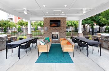 Summerhouse with fireplace, seating and gas grills